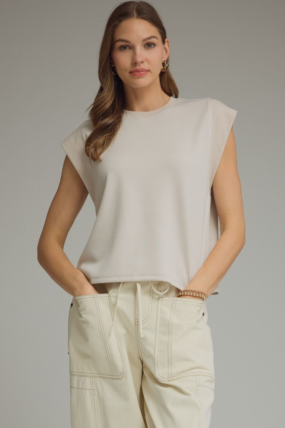 Solid round neck cap sleeve top featuring ribbed trim
