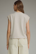 Solid round neck cap sleeve top featuring ribbed trim