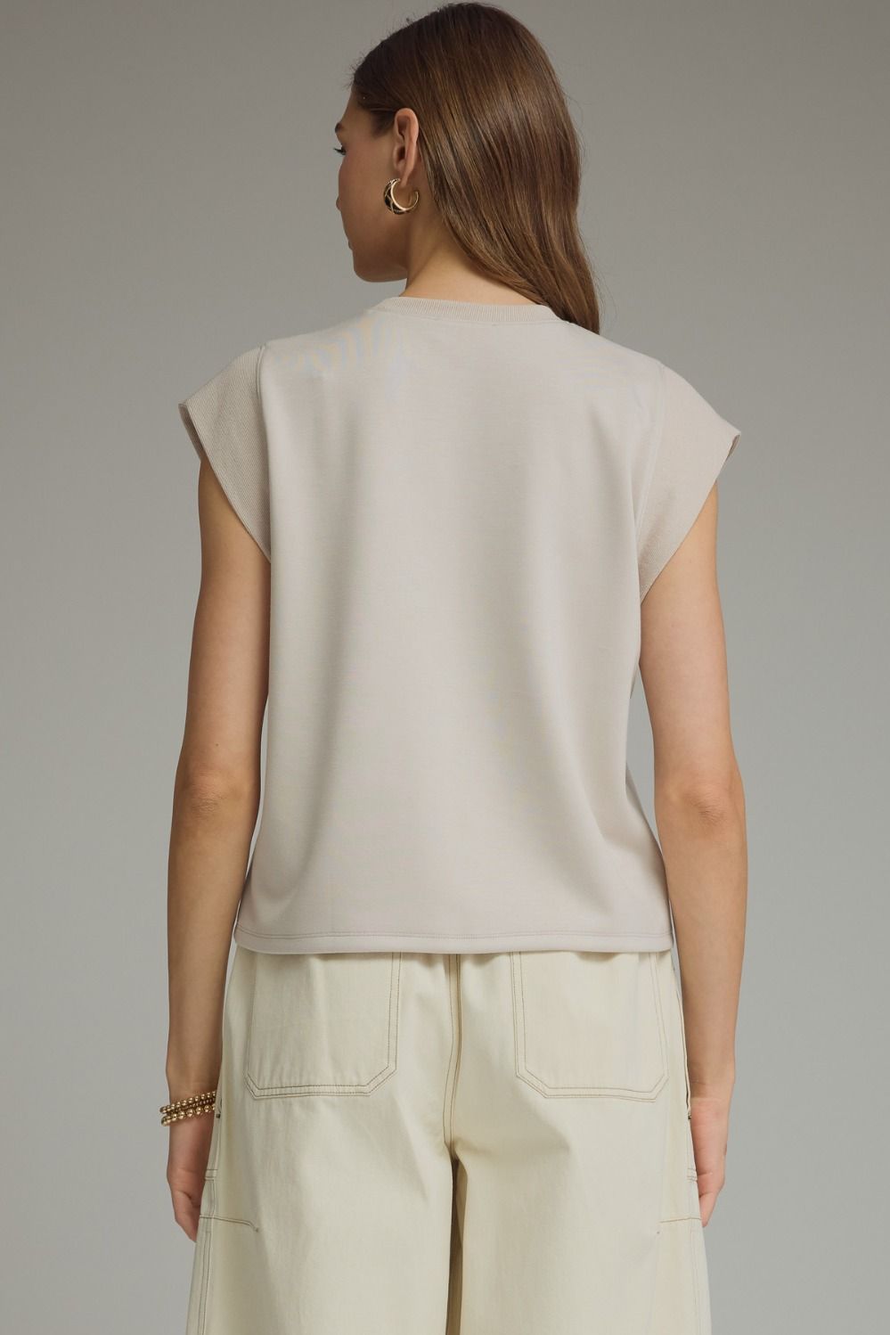 Solid round neck cap sleeve top featuring ribbed trim